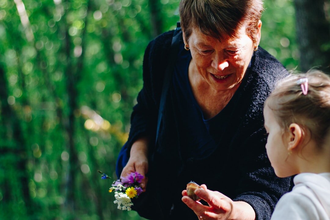 Grandparent holding hands with a young grandchild outdoors