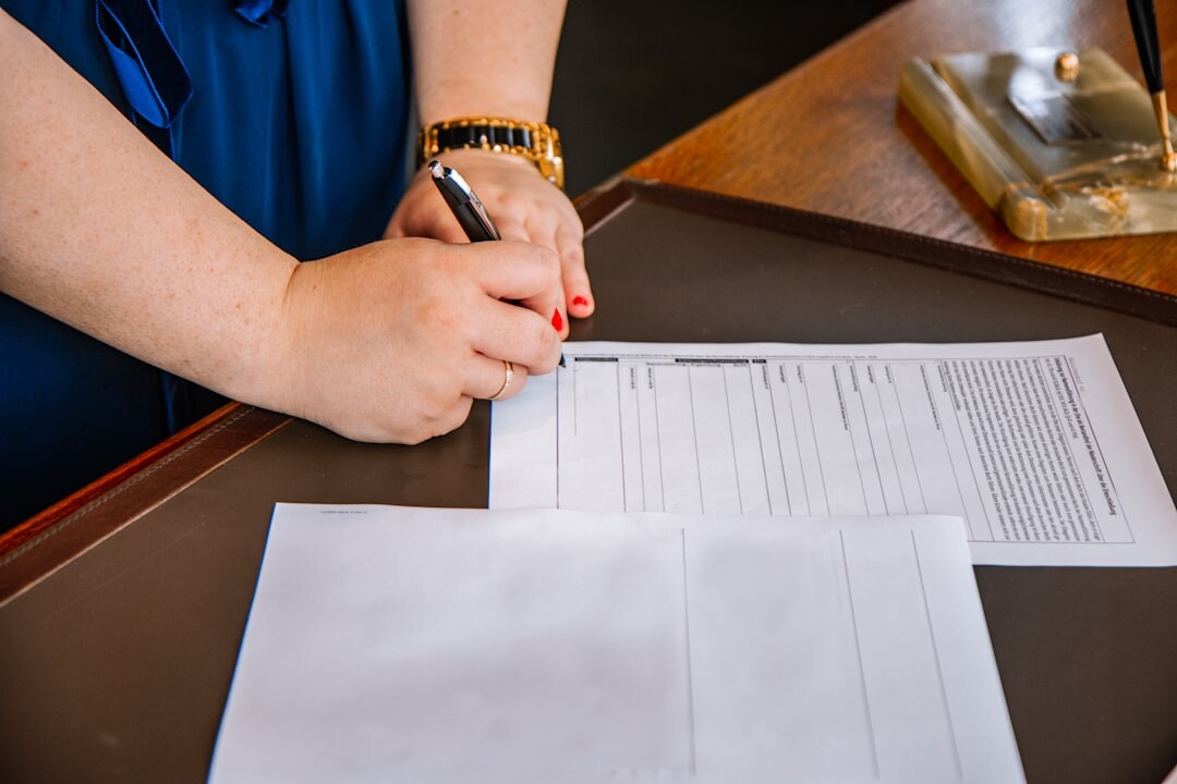 Close-up of hands signing an official inheritance document
